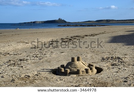 A sand castle and Dunstanburgh Castle