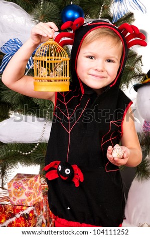 A girl under the Christmas tree with gifts, the girl is happy snowfall and catches it with his hands