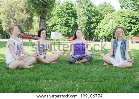 Cute Hispanic women practicing the cobra pose during their yoga class in a gym