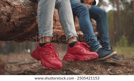 Similar – Image, Stock Photo Baby legs dangling from high chair; baby wearing turquoise outfit with bare feet against white wood background