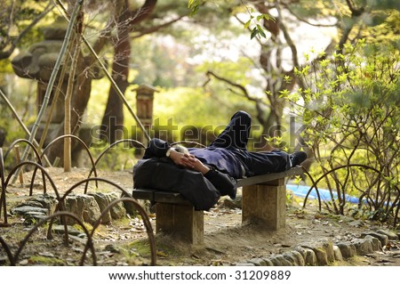 Man sleeping on park bench
