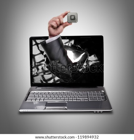CONCEPT. laptop with broken screen and hand hand holds the processor CPU High resolution
