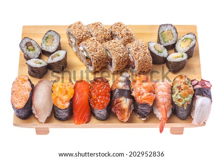 Big Sushi and roll set on wooden board isolated on white background