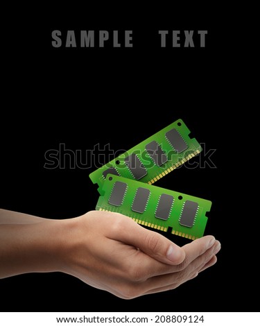 RAM Memory Card. Man hand holding object isolated on black background. High resolution