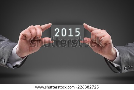 businessman hands holding object board with number 2015 High resolution