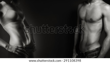 portrait of a sexy muscular shirtless man and fit woman black and white
