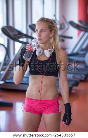 Fitness woman relax with water bottle after exercise