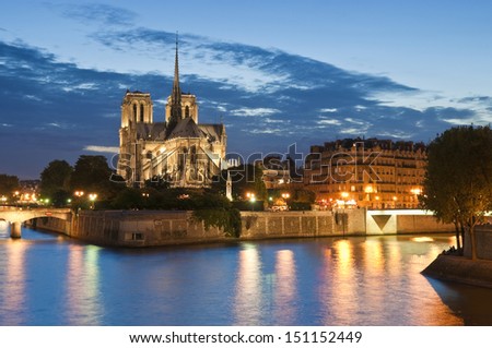 Evening illuminations of the stunning Notre-Dame Cathedral (1163) and parisian apartments along the banks of the river Siene, Paris.