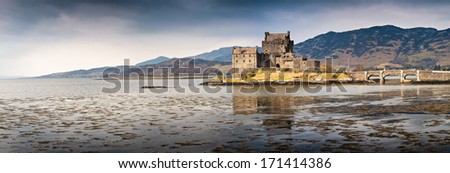 Eilean Donan castle in Loch Duich surrounded by the mountains of the Scottish Highlands.