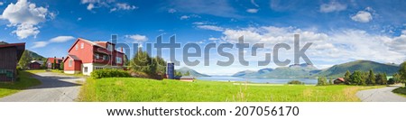 Idyllic rural scene with lakes, mountains and big sky vista, Norway.