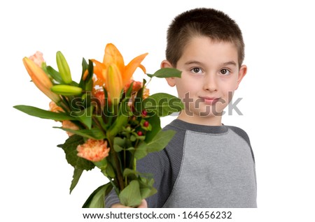 Eight years old boy presenting flowers to someone, perhaps its National Teacher Appreciation Day