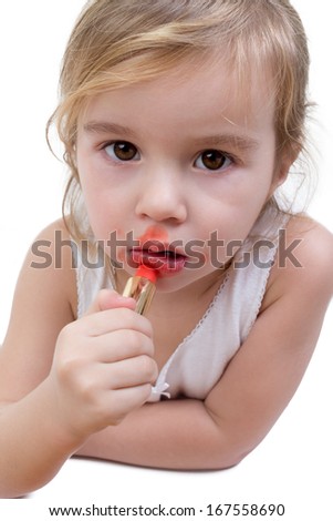 Portrait of a small girl who has been playing with her mother\'s lipstick, and applied it all around her mouth
