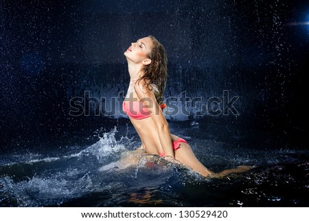 Young sexy woman. Water studio photo.
