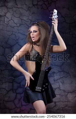 Woman playing music on a bass guitar