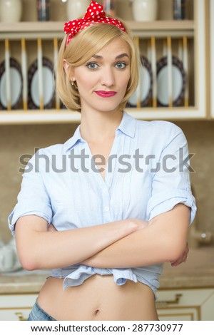 Beautiful pin-up girl on a kitchen. Retro style. Fashion.