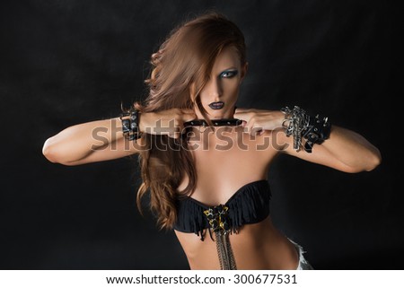 Fashion Rocker Style Model Girl Portrait. Hairstyle. Rocker or Punk Woman Makeup and Hairdo.