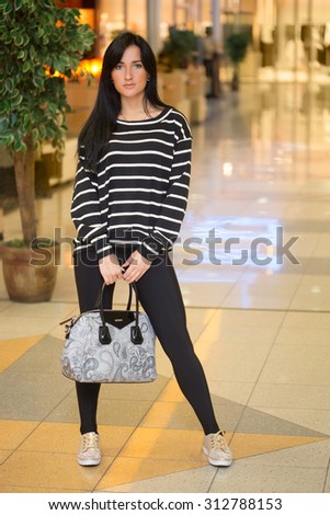 girl in a striped blouse with a bag