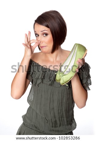 woman smells bad odor on her shoes