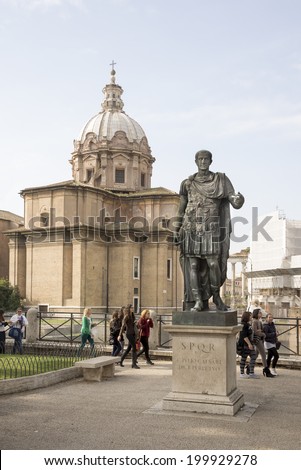 ROME,ITALY-APRIL 02- Tourists walk around the monument to Julius Caesar on April 02, 2014 in Rome