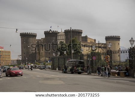 NAPLES,ITALY-APRIL 03-Transport moves around  Castel Nuovo (Anjou dungeon). Vendors selling souvenirs  on April 03,2014 in Naples