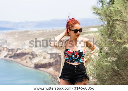 Beautiful young lady wearing short jeans and a flower printed crop top