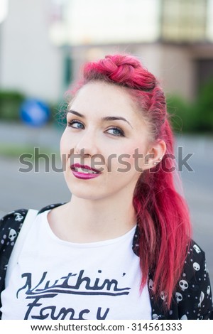 Beautiful redhead with a pony tail hairdo and blue eyes