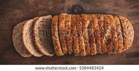 Top view of sliced wholegrain bread on dark ructic wooden  background closeup Stock foto © 
