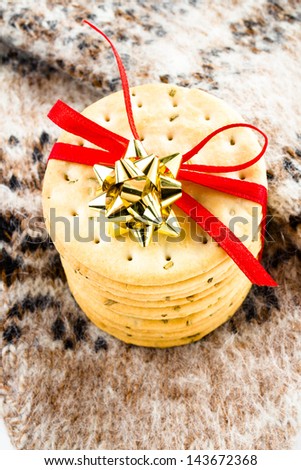 Christmas  cookies with red ribbon and knitted winter mitten
