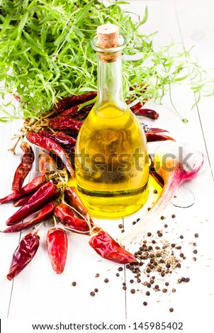 Olive oil bottle, herbs and Red hot chili pepper on white
