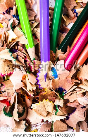 Colored Rainbow pencils and Heap of Color pencil shaves background