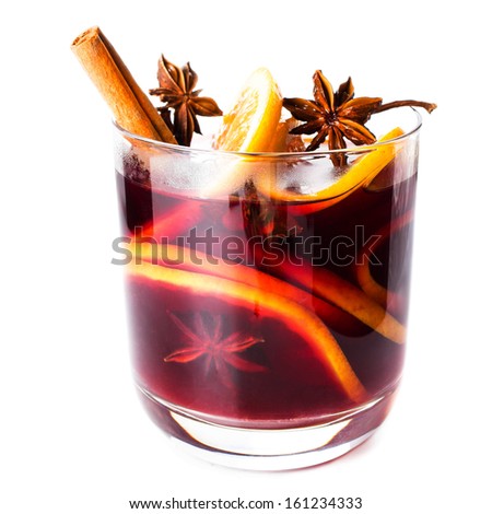 Hot red mulled wine isolated on white background with christmas spices, orange slice, anise and cinnamon sticks, close up. Сток-фото © 