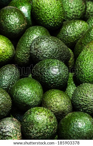 Avocado background. Fresh green avocado on a market stail. Food background.