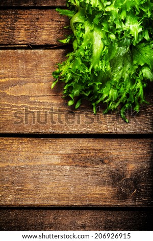Fresh Salad over wooden background.  Diet Food and healthy lifestyle concept. Lettuce Salad background with copyspace.