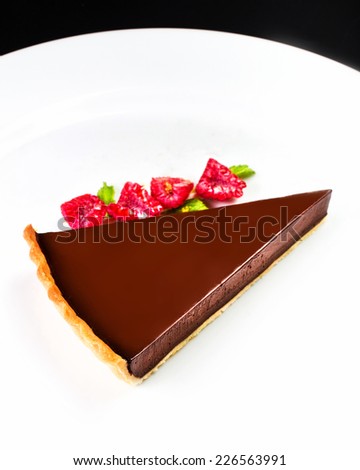 Chocolate dessert with raspberry. Chocolate cheesecake with raspberries. Dark chocolate cake with chocolate sauce macro