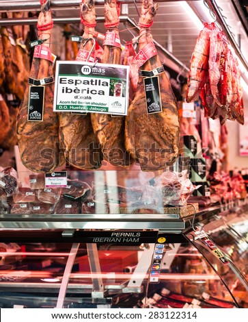 BARCELONA, SPAIN - MAY 12, 2015: Meat shop with Iberian Ham at Bokeria Food Market. Fresh red meat at the butcher. Hamon iberico