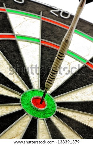 Single dart hitting the Bullseye of a dart board