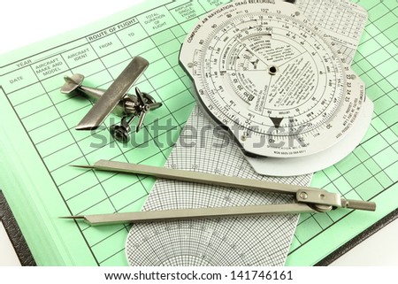 Toy airplane, pilot log book, metal wizz wheel (E6B or CRP-1) flight calculator and engineering dividers