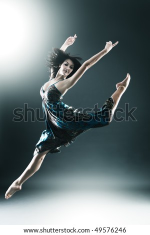 Stylish and young modern style dancer is jumping stretched