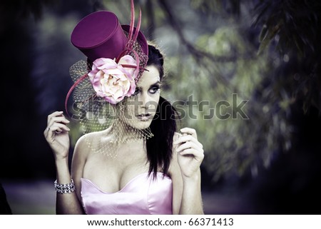 Face of young beautiful woman in a vintage hat outdoors