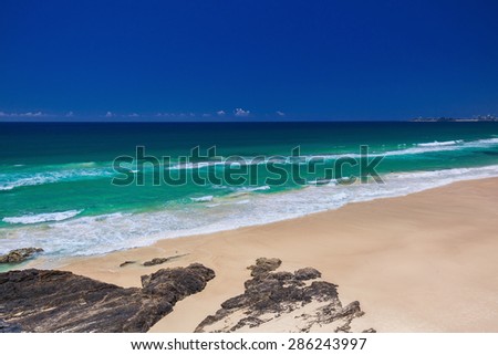 Tropical beach with surf waves on Gold Coast, Queensland, Australia