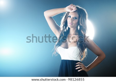 Beautiful woman on dark background with blue lights