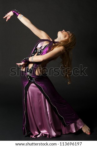 Beautiful woman is dancing the oriental dance