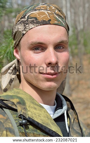 A portrait of the young man in forest.