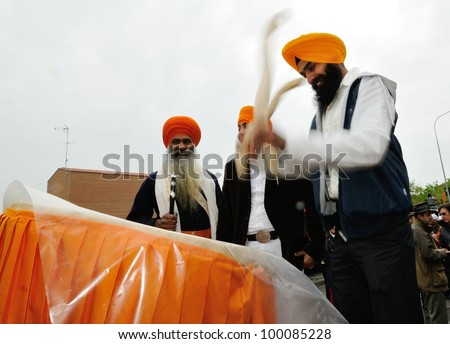BRESCIA ITALY - APRIL 14: Sikh drummer beats his drum on a pickup truck at the Baisakhi (harvest) Sikh festival, on April 14, 2012 in Brescia