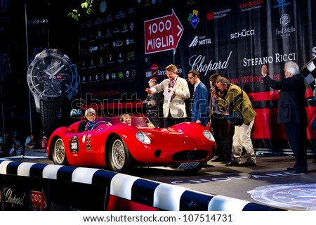 BRESCIA ITALY - MAY 17: Red 1957 Maserati 200 SI driven by M. Kurihara starts the 1000 Miglia 2012, on May 17, 2012 in Brescia