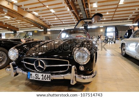 BRESCIA ITALY - MAY 16: Black Mercedes 300 SL Gullwing  veteran car, waits for scrutineering before 1000 Miglia historic car race in a fair hall, on May 16, 2012 in Brescia
