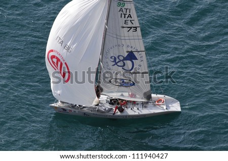 GARGNANO (BS) ITALY - SEPTEMBER 2: Tasso Etilico sailing boat, Asso99 class, skipper Albino Fravezzi, starts the Trofeo Gorla regatta, on September 2, 2012 in Gargnano (BS)
