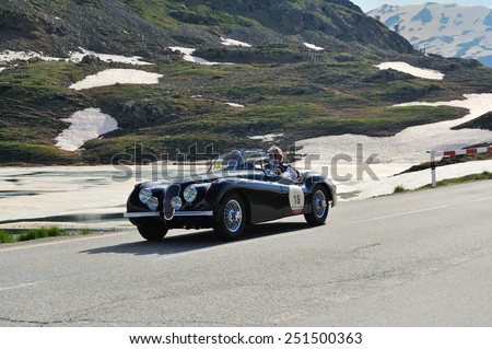 BERNINA PASS, SWITZERLAND - JUNE 14: A black Jaguar XK 120 OTS takes part to the Summer Marathon classic car race on June 14, 2014 at Bernina Pass. This car was built in 1950