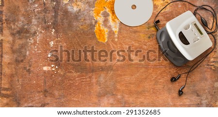 CD player on brown wood background for listen and design.