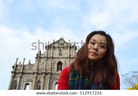 young girl in front of landmark head turn right